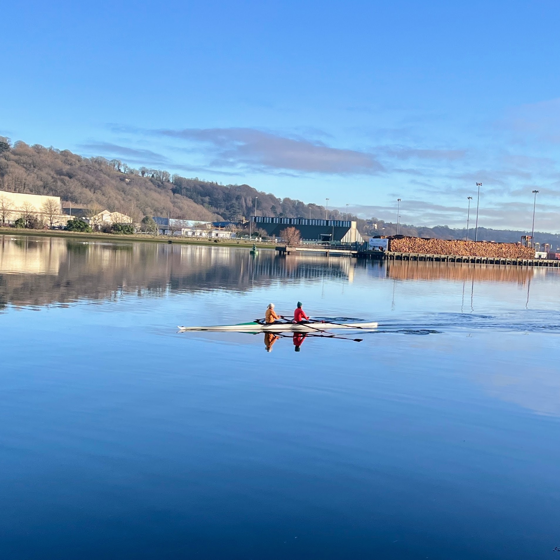 Rowers on the calm water of the River Lee beside the Marina in Cork