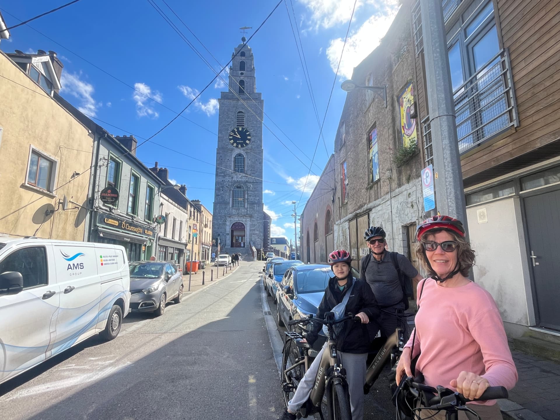 Guests standing with their bikes, including an electric bike, in Cork City