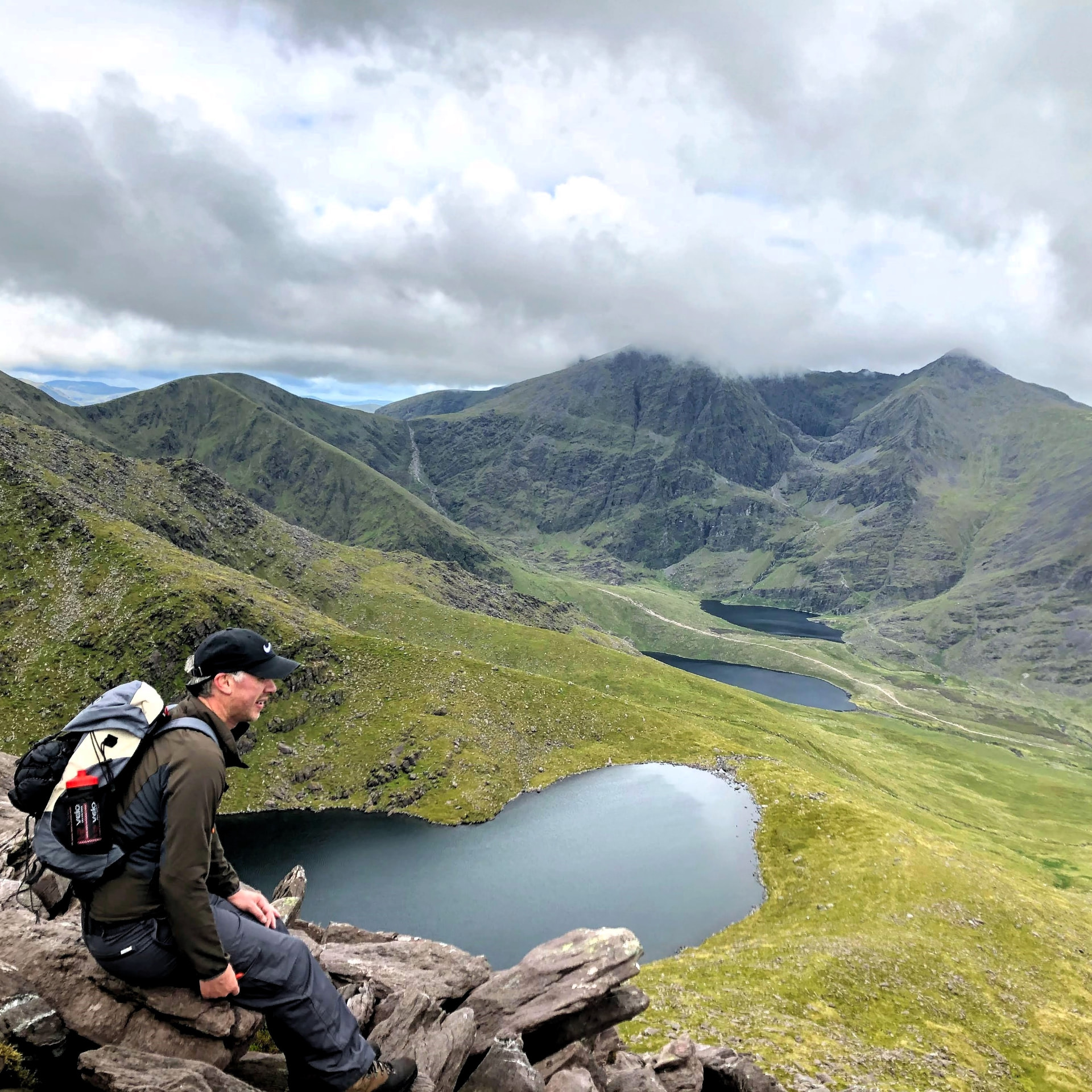 Walker resting above the mountain lakes below Carrauntoohil in Kerry