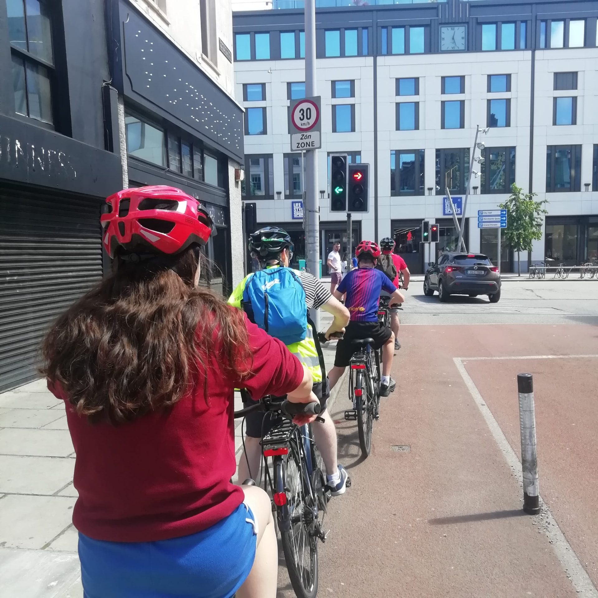 Cyclists waiting at a traffic light in Cork city centre